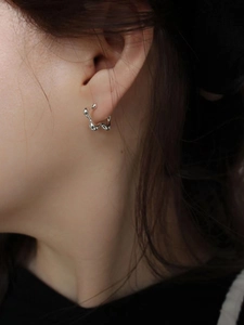 Minimalist 925 sterling silver wavy hoop earrings featuring an organic irregular design