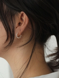 Minimalist 925 sterling silver hoop earrings with irregular beaded texture on a model