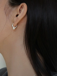 Elegant silver pearl hoop earring for women shown on a model with minimalist style