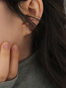 Minimalist gold hoop earring with chain texture shown on model for a sleek daily style