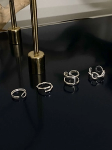 Set of four minimalist silver open rings including bamboo texture and chain designs