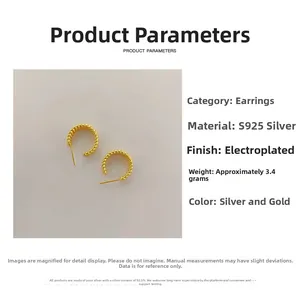 Macro detail of gold S925 silver C-shape twisted earrings with textured finish