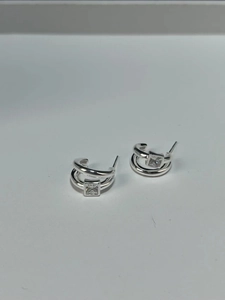Detailed view of 925 sterling silver multilayer earrings with square zircon stone