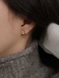 Elegant S925 sterling silver gold-plated earrings with clear zircon on model's ear