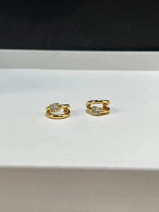 Detailed macro view of gold plated 925 silver double layer earrings with square zircon stone