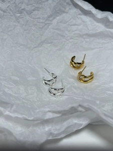 Close-up of 925 sterling silver C-shaped hoop earrings with square zircon stones