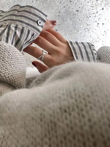 Detail of 925 sterling silver double layered cross winding ring on model hand