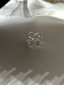 Macro view of geometric 925 sterling silver hollow overlapping rings with a polished finish