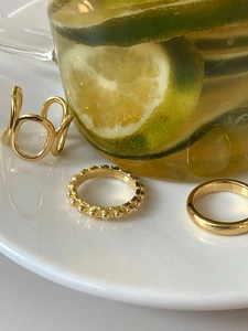 Three-piece set of gold 925 sterling silver rings including textured and smooth bands