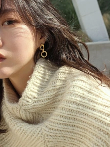 Elegant gold geometric 925 silver double hoop earrings worn by a model in natural light