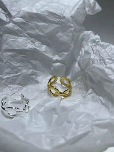 Detailed view of gold and silver chain link open rings with S925 hallmark on inner band