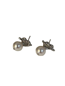 Minimalist silver knotted stud earrings with white pearls on a clean white background