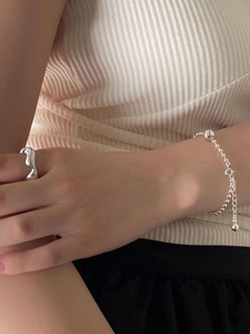 Detail of 925 sterling silver beaded bracelet and irregular minimalist ring on model