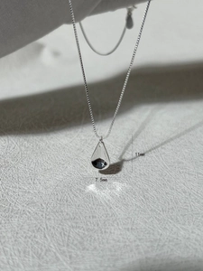 Detailed size view of silver teardrop pendant 11mm by 7.5mm on thin box chain necklace
