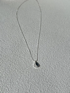 Minimalist S925 sterling silver necklace with a polished teardrop pendant on a white surface