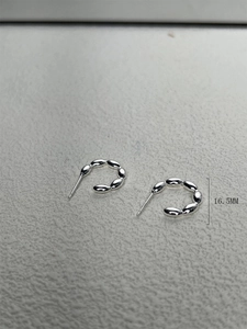 Macro detail of 16.5mm S925 sterling silver beaded hoop earrings with a sleek minimalist design