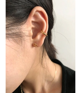 Detail of 925 sterling silver hollow heart earrings and knot studs in gold plating