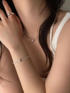 Detail of 925 sterling silver beaded bracelet and ring set on a female model