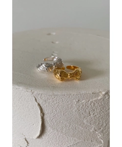 Macro detail of S925 sterling silver bow rings with vintage wrinkled texture