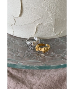 Macro shot of silver and gold bow rings with S925 engraving on textured background