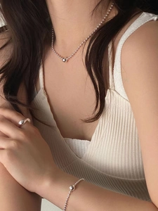 Detailed view of 925 sterling silver ball chain necklace, bracelet and smooth wide ring set