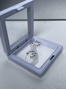 Detailed view of S925 sterling silver beaded hoop earrings in a clear jewelry gift box
