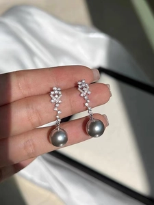 Detailed view of silver grey 12mm large pearl drop earrings with micro-pave cubic zirconia