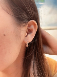 Minimalist S925 sterling silver beaded hoop earrings worn by a model in natural light
