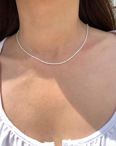 Elegant S925 sterling silver shimmering chain necklace worn by a model on collarbone