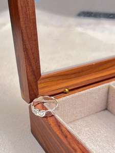 Retro S925 sterling silver open ring with embossed smiley faces and hearts on wood stand