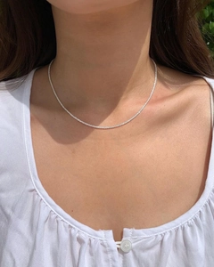 Sparkling S925 sterling silver thin shimmer chain necklace worn on a woman's neck