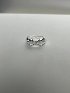 Detail view of adjustable S925 sterling silver bow ring with engraved hallmark stamp
