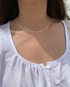Elegant s925 sterling silver shimmering star chain necklace worn on a woman's neck