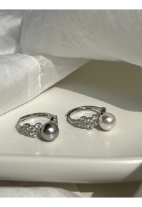Detail of S925 sterling silver adjustable rings with pearls and sparkling zircon accents