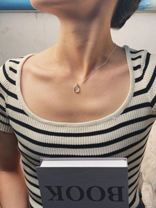 Minimalist 925 sterling silver necklace with oval open pendant shown on a model