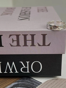 Close-up of S925 silver open ring with vintage engraved floral and smiley heart patterns