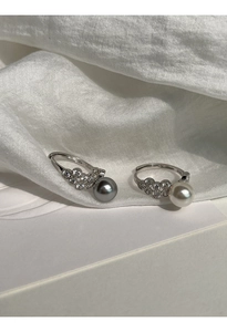 Close-up of S925 silver rings with white and grey pearls and micro-pave zircon accents