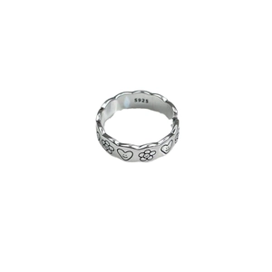Vintage S925 sterling silver open ring with smiling heart and flower patterns on white base