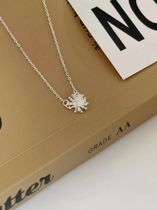 Elegant S925 sterling silver snowflake pendant necklace shown on a warm gift card