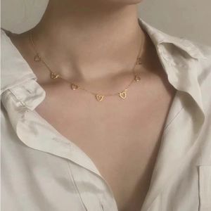 Elegant 925 sterling silver gold heart necklace on model with white shirt