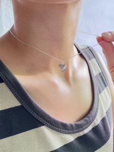 925 sterling silver heart pendant necklace with sunburst texture worn by a model