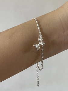 Minimalist 925 sterling silver beaded bracelet featuring a delicate butterfly charm pendant