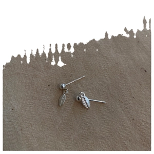 Minimalist S925 sterling silver leaf drop earrings with polished finish on burlap
