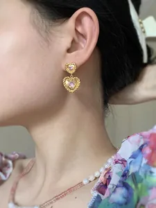 Boucles d'oreilles cœur vintage en argent 925 doré avec zircons roses sur mannequin