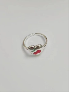 Macro shot of 925 sterling silver heart ring with red cherry enamel and S925 hallmark