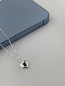 925 silver heart necklace with black teardrop agate pendant shown next to a blue phone