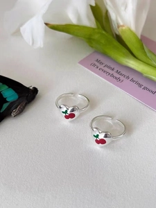 Detail of 925 sterling silver open rings featuring sweet red cherry heart motifs