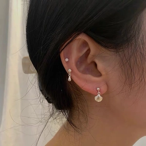 S925 silver shell and mermaid tail stud earrings set worn on model earlobe