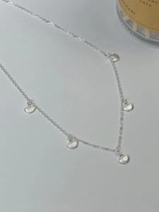 Detail of S925 silver choker necklace featuring five small seashell charms on a fine chain
