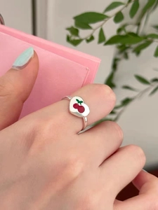 925 silver open ring with white heart and red cherry pattern worn on a hand